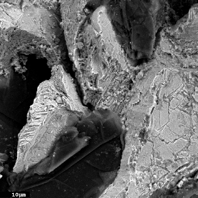 Fractographic detail of the interconnected graphite flakes and corroded matrix.