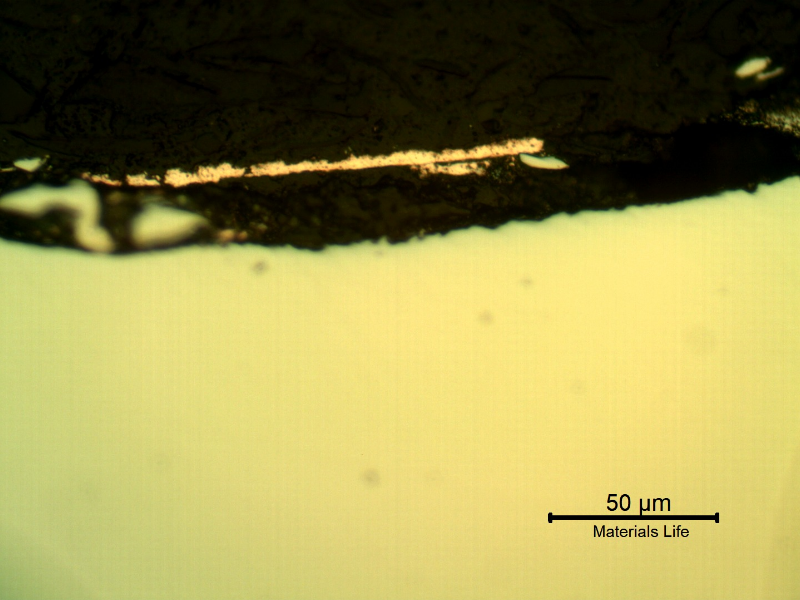 Micrographic detail of the plate section, as polished, close to the surface that suffered the impact.  The orange is the copper alloy melted film.