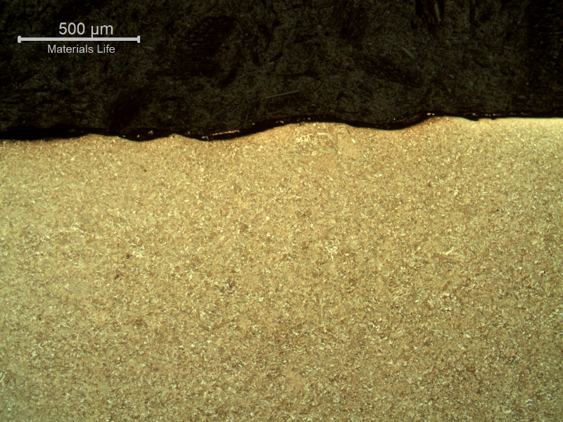 Micrography of the plate section, close to the surface that suffered the impact.  Smooth waves but no evidences of damage.