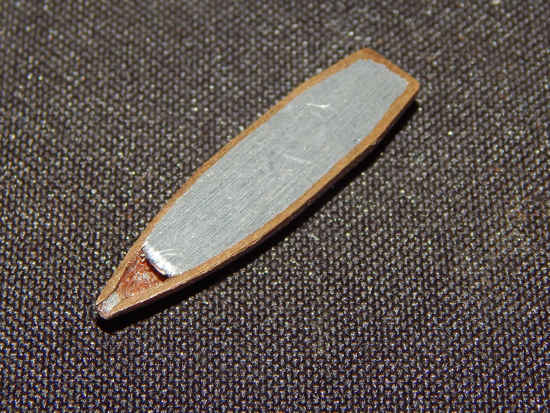 Aspect of a typical .308 Winchester projectile, similar to the one adopted to shot the plate, cut in a longitudinal section.  It  is a Cu alloy case filled with Pb-Sb.