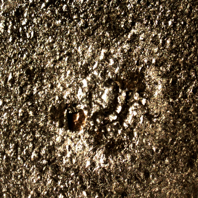 Detail of the position in the plate of impact with the projectile.  No damage, only particles adhered at the surface.