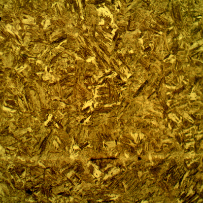 Micrographic detail of the high hardness martensitic structure. Exactly in the middle of the plate it is possible to see some aligned inclusions.