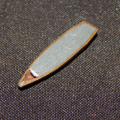 Aspect of a typical .308 Winchester projectile, similar to the one adopted to shot the plate, cut in a longitudinal section. It is a Cu alloy case filled with Pb-Sb.