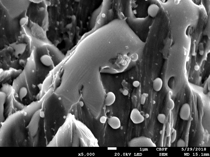 Detail of the plate surface a little far from the perforated hole, in the side where the projectil stroke the plate. Drops of melted material from the bullet.