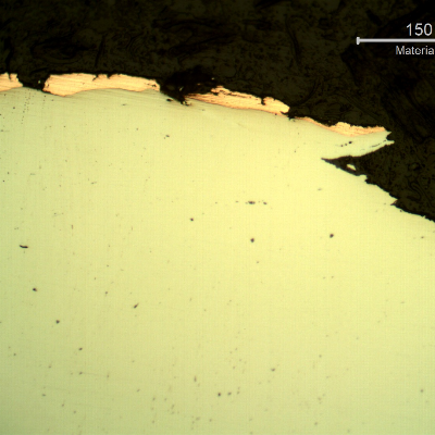 Micrographic detail of the plate section, as polished, close to the surface that suffered the impact. The copper alloy melted and created  a yellow-orange deposit.