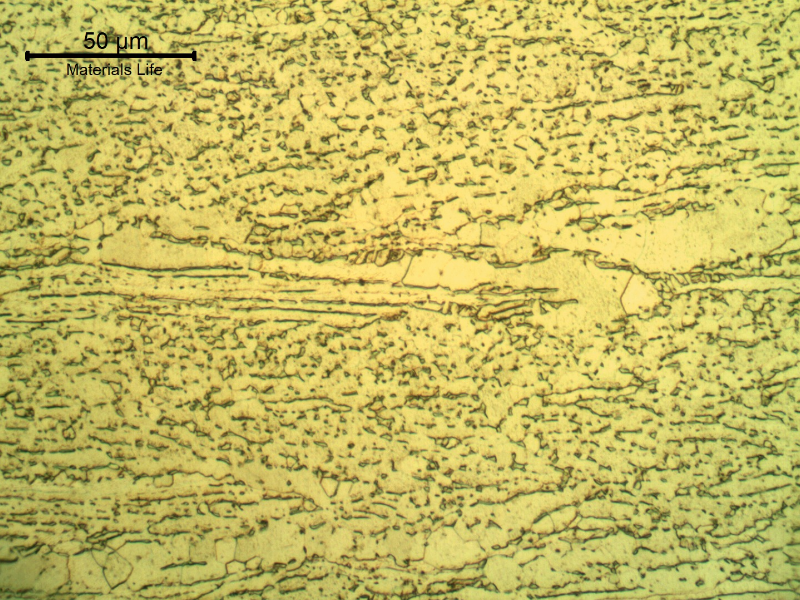Micrographic detail of the plate, showing the aligned beta phase (dark) in the alpha grains (light) microstructure. Etched with HF (10%) + HNO3 (5%) +H2O (85%) solution.