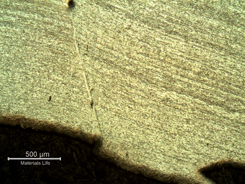 Micrography of the 3/8" thickness titanium alloy plate, in a section, close to the end of the plate in the opposite side of the projectile impact. The plate was sheared through wall in a very localized position.  HF+HNO3+H2O chemical etch.