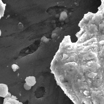 Detailed aspect of the surface of the plate at the projectile impact position.