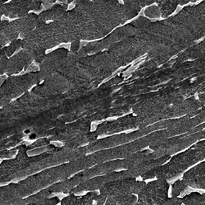 Micrographic detail by scanning electron microscopy of the very localized plastic deformation between inclusions in the material creating longitudinal ductile secondary cracks. HF+HNO3+H2O chemical etch.