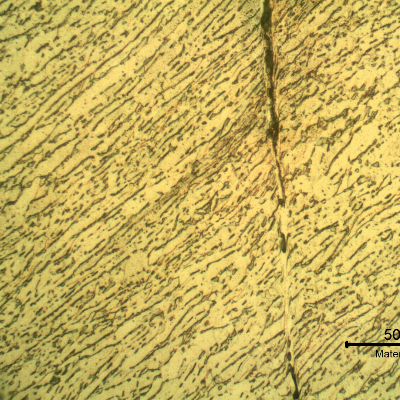Micrographic detail of the shearing of the material due to the projectile impact. It is a very localized effect. HF+HNO3+H2O chemical etch.
