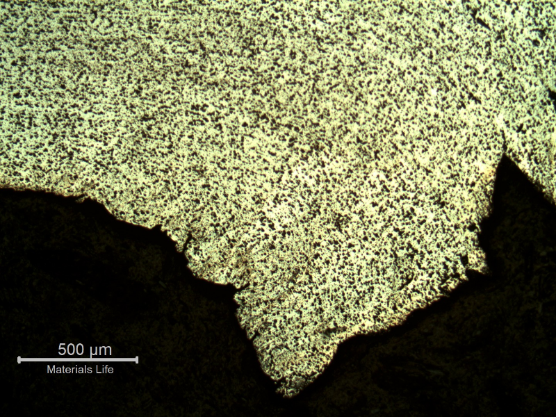 Micrography of the plate at opposite face to the projectile impact (where the bullet exited), showing ductile microcracks.