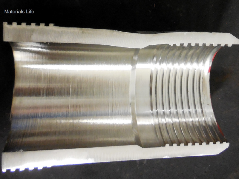 The longitudinal section of the pin shows that it was deformed in a localized position, where the layer was detached, top side of the figure. The pin wall was plastically deformed decreasing the internal diameter.