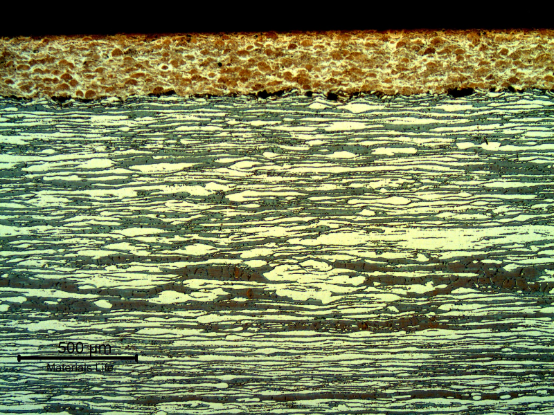 Micrography of a longitudinal section, at the surface of the pin, where the thermal spray layer is sound. The thickness of the layer is about 0.3 mm.