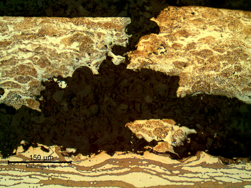 Micrographic detail of the damage surface layer, detached and broken.  The substrate is not affected and the rupture of the layer is typically by overloading.