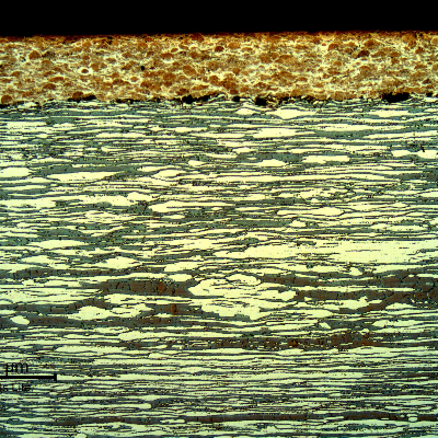 Micrography of a longitudinal section, at the surface of the pin, where the thermal spray layer is sound. The thickness of the layer is about 0.3 mm.