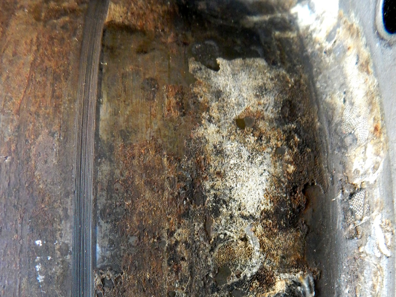 Macroscopic aspect of the outer diameter of the flanged sleeve presenting adhered products at the surface. The flanged sleeve was manufactured by centrifugal casting in a lean duplex stainless steel and it was externally coated by thermal spray (TS) in a position of sealing.  After 5 years in service the system suffered leakage.
