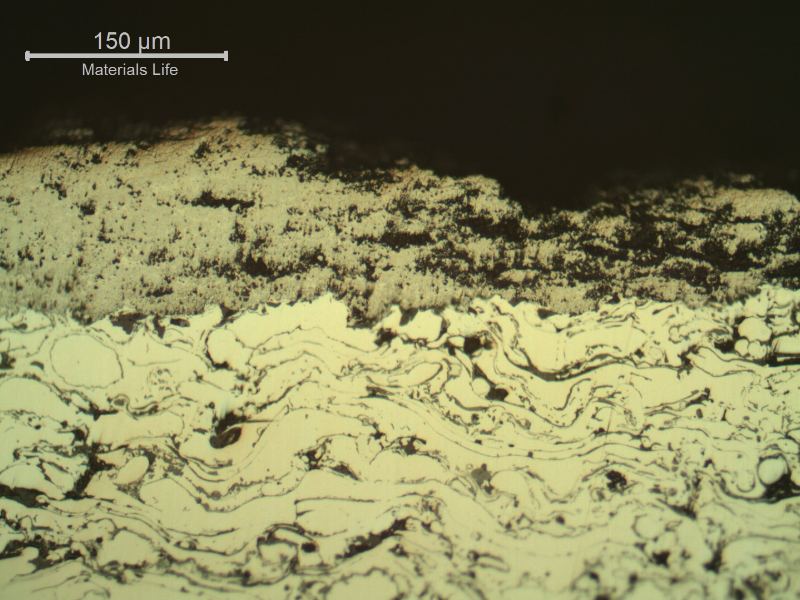 Micrographic detail of a longitudinal section of the sleeve, in a region where the WC (tungsten carbibe) surface layer was degradated and partially removed.