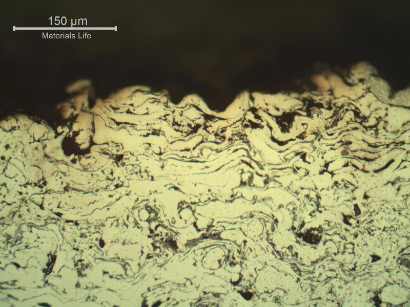 Micrography of a longitudinal section of the sleeve, in a region where the surface layer was completely removed.  In this position only the stainless steel layer, that is porous and full of oxides, is at the surface. That is why the sealing condition was lost.