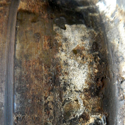 Macroscopic aspect of the outer diameter of the flanged sleeve presenting adhered products at the surface. The flanged sleeve was manufactured by centrifugal casting in a lean duplex stainless steel and it was externally coated by thermal spray (TS) in a position of sealing.  After 5 years in service the system suffered leakage.