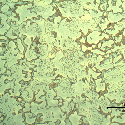 Micrography of the longitudinal section of the cast sleeve in the middle of the thickness. The microstructure is duplex, austenitic and ferritic.  The etch presents different colours for the phases.  The yellow is associated to detrimental phases, like sigma, at the ferritic phase (ligh blue) and the white phase is the austenite.