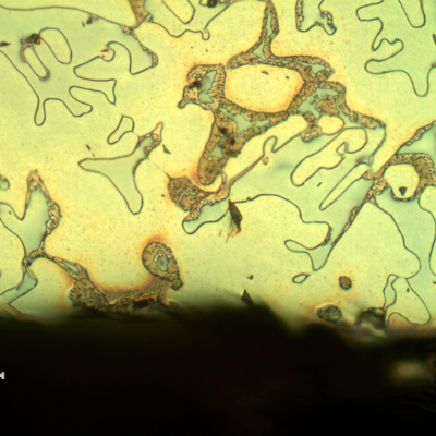 Micrographic detail of the longitudinal section of the cast sleeve at the ID. The microstructure is duplex, austenitic and ferritic.  The etch presents different colours for the phases.  The yellow is associated to detrimental phases, like sigma, at the ferritic phase (ligh blue) and the white phase is the austenite. No evidences of corrosion. The environment in this position is non corrosive, oil.