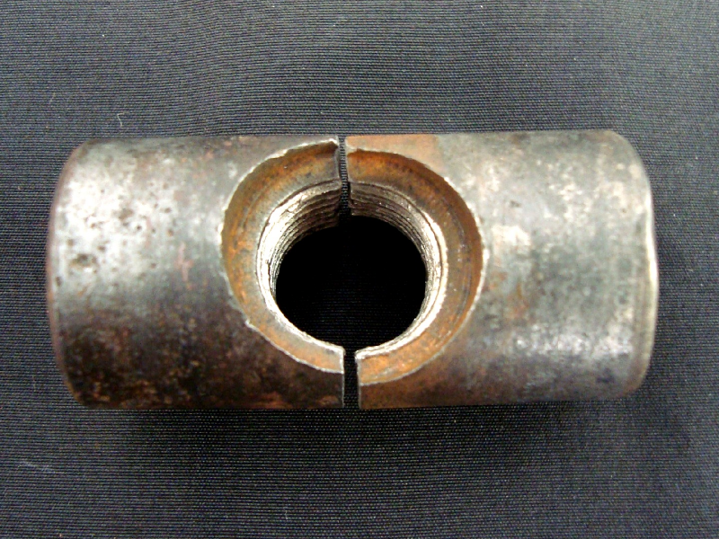 Aspect of the barrel nut that is broken in a brittle way (without plastic deformation).  The Nut diameter is 1", the nut length is 2" and the bolt thread is 1/2" (nominal diameter).
