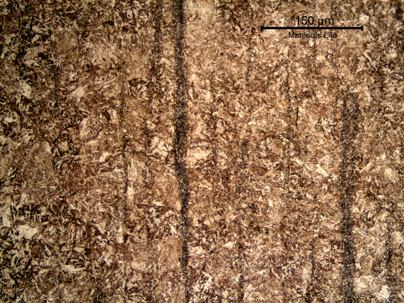 Microstructural detail of the banded structure. The rough aspect of the band is created by the carbides (better seen in the higher magnification image) in the segregation band.
