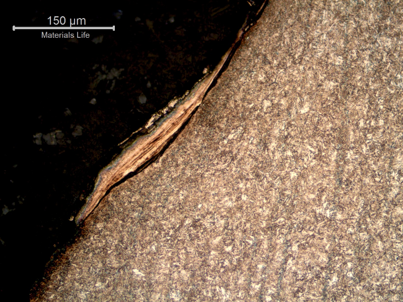 Micrography of the nut in the longitudinal section, plastic deformation at the thread surface due to high local stresses, probably during assembling.