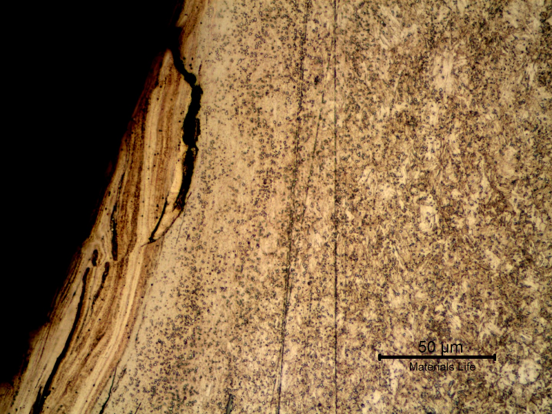 Micrographic detail of the nut in the longitudinal section, presenting cracks associated to the plastic deformation at the thread surface. These cracks were formed due to high local contact stresses.
