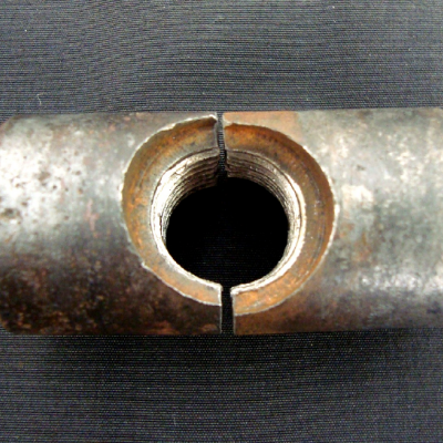 Aspect of the barrel nut that is broken in a brittle way (without plastic deformation).  The Nut diameter is 1", the nut length is 2" and the bolt thread is 1/2" (nominal diameter).
