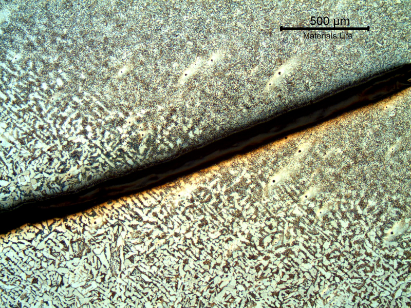 Micrography of a section tranverse to the pipe and to the weld between the 8"pipe and the 2" fitting weldolet.  The crack starts exactly at the margin of the weld and propagates in the pipe longitudinal direction, in a straight line, not related to any metallurgical aspect.