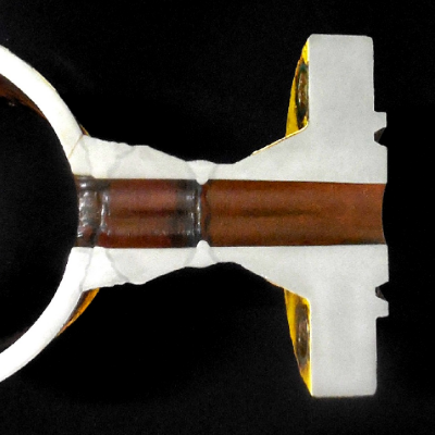 Macrography of the 8" pipe, welded to a 2" fitting (weldolet), welded to a 2" flange. The branch line was operating in this position (horizontal line with a lateral branch) and the through thickness fatigue crack is associated to the margin of the weld in the upper part of the pipe.