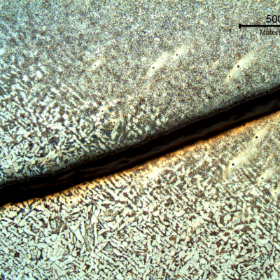 Micrography of a section tranverse to the pipe and to the weld between the 8"pipe and the 2" fitting weldolet.  The crack starts exactly at the margin of the weld and propagates in the pipe longitudinal direction, in a straight line, not related to any metallurgical aspect.