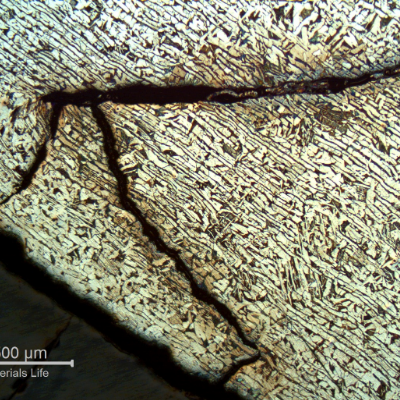 Micrography of a section tranverse to the pipe and to the weld between the 8"pipe and the 2" fitting weldolet.  The crack starts exactly at the margin of the weld and propagates in the pipe longitudinal direction, in a straight line until it reaches the condition of overloading and through wall final rupture, with strong plastic deformation as can be seen around the crack.
