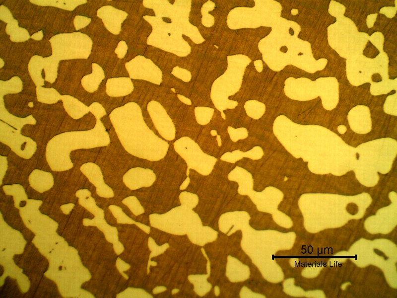 Micrography of a transverse section of the fititng, presenting a coarser structure. The ferrite is red/orange and the austenite is white/yellow.