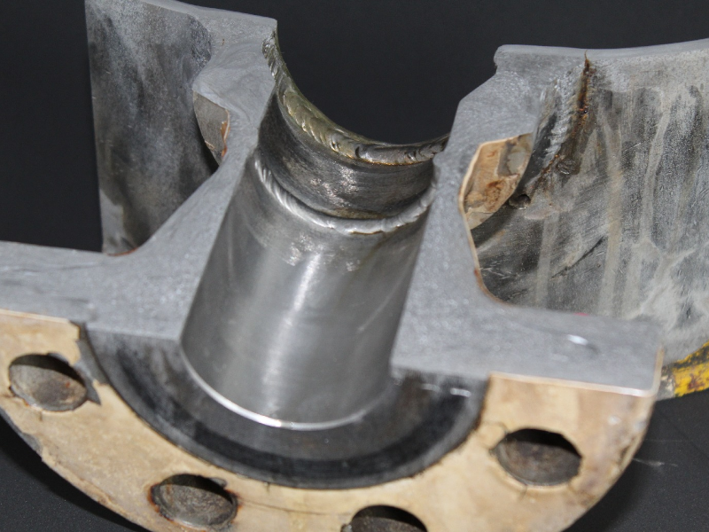 Macrography of the section transverse to the ND 14" main pipe (that is only 5mm thick) and to the ND 2" branch that is a weldolet fitting welded to the main pipe and flange. This image is interesting because it shows clearly how thin is the pipe compared with the fitting thickness and the large amount of welding required to assure a full penetration weld in the weldolet.