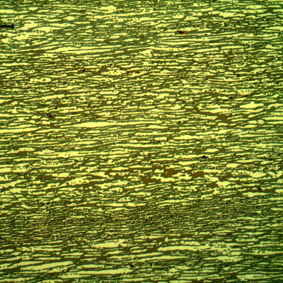 Micrography of a transverse section of the pipe, presenting a refined duplex structure. The ferrite is blue/red and the austenite is white/yellow.