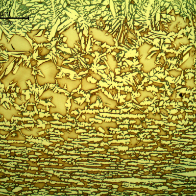Micrography of the heat affected zone of the pipe to the fitting, at the pipe position. Base metal to the bottom of the figure and fusion line to the top.