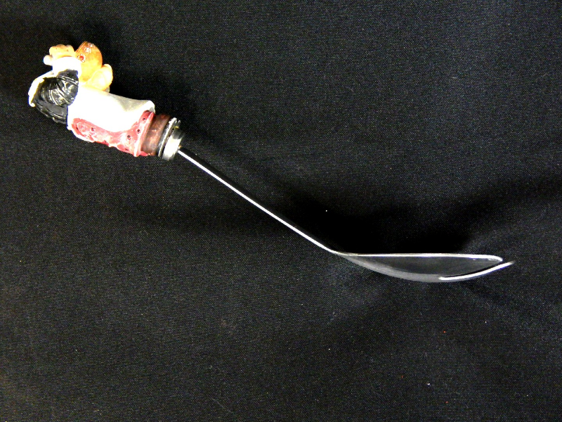 Lateral view of the fork showing the profile. The scoop convex depth is 10 mm and the handle concave depth is 3 mm. The overal thickness of the part is 1 mm.