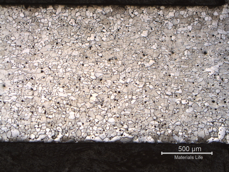 Micrography of a longitudinal section of the fork, at the scoop to handle position (scoop to the right of the figure and handle to the left). The full thickness is presented in the image and it is possible to see that in the handle location the ferritic grains are larger in the center of the thickness than close to the surfaces, and in the scoop position the grains tend to be more uniform through the thickness.