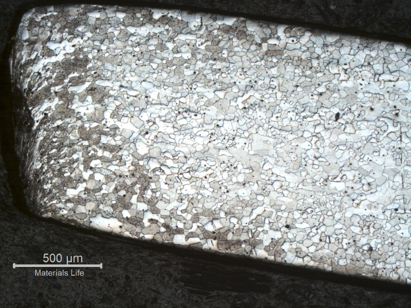 Micrography of the longitudinal section from the fork tooth in the scoop. The microstructure is the same as in the scoop close to the handle, but at the cut surface the structure presents strong plastic deformation generated by a mechanical cutting.