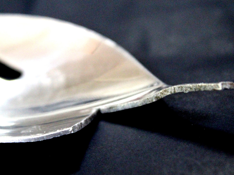 The fork scoop is about 53 wide and there is a transition to the handle that is 9mm wide. Exactly at that transition the fork was cut in a longitudinal section and the profile is shown in this figure. The thickness is 1mm and the curvatures of the scoop and handle are in different directions, 3mm depth concave in the handle and 10 mm depth convex in the scoop.