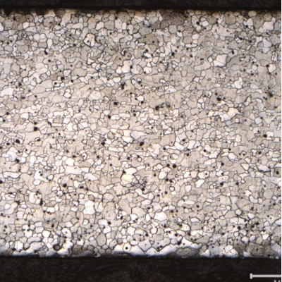 Micrography of a longitudinal section of the fork, at the scoop to handle position (scoop to the right of the figure and handle to the left). The full thickness is presented in the image and it is possible to see  that in the handle location the ferritic grains are larger in the center of the thickness than close to the surfaces, and in the scoop position the grains tend to be more uniform through the thickness.