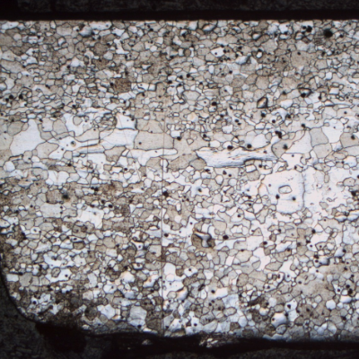 Micrography of a fork longitudinal section, at the handle (close to the transition betwee the scoop and handle). The full thickness is presented in the image and it is possible to see  that the ferritic grains are larger in the center of the thickness than close to the surfaces.