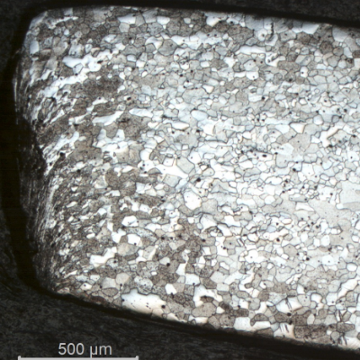Micrography of the longitudinal section from the fork tooth in the scoop. The microstructure is the same as in the scoop close to the handle, but at the cut surface the structure presents strong plastic deformation generated by a mechanical cutting.