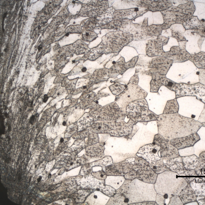 Micrography of the longitudinal section from the fork tooth in the scoop. The microstructure is the same as in the scoop close to the handle, ferritic grains equiaxial and uniform, but at the cut surface the structure presents strong plastic deformation generated by a mechanical cutting.