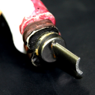 The metallic part of the fork handle is about 9mm wide. It was cut in a transverse section and the profile is shown in this figure. The thickness is 1mm and the curvature depth is about 3mm.