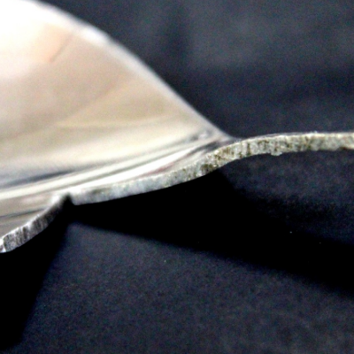 The fork scoop is about 53 wide and there is a transition to the handle that is 9mm wide. Exactly at that transition the fork was cut in a longitudinal section and the profile is shown in this figure. The thickness is 1mm and the curvatures of the scoop and handle are in different directions, 3mm depth concave in the handle and 10 mm depth convex in the scoop.