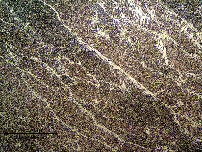 Micrography of the weld metal in the last bead, presenting previous austenite columnar grains, primary ferrite in the grain boundaries, some regions of ferrite with aligned second phases and acicular ferrite.