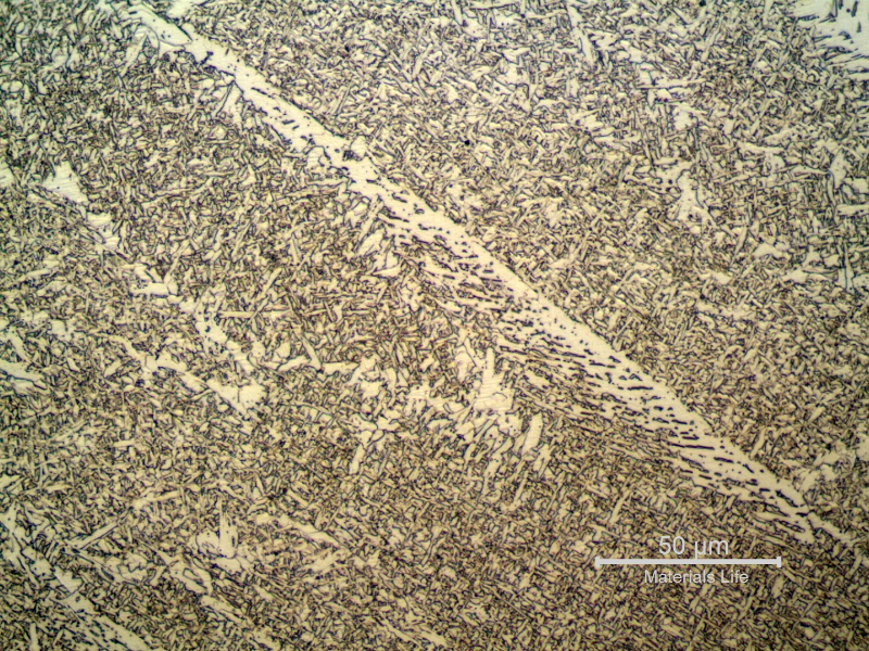 Micrographic detail of the weld metal in the last bead. The microstructure shows primary ferrite in the (previous austenite) grain boundaries, some regions of ferrite with aligned second phases and acicular ferrite in the center of the columnar grains.